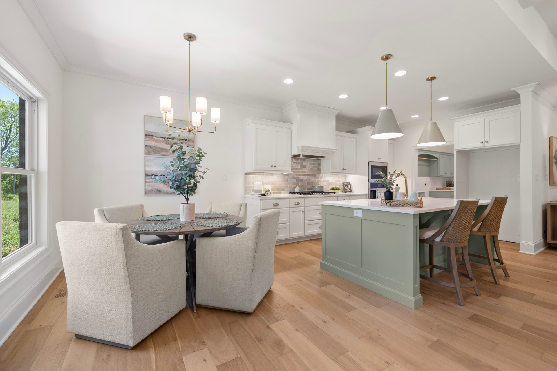Kitchen and breakfast nook with sage island