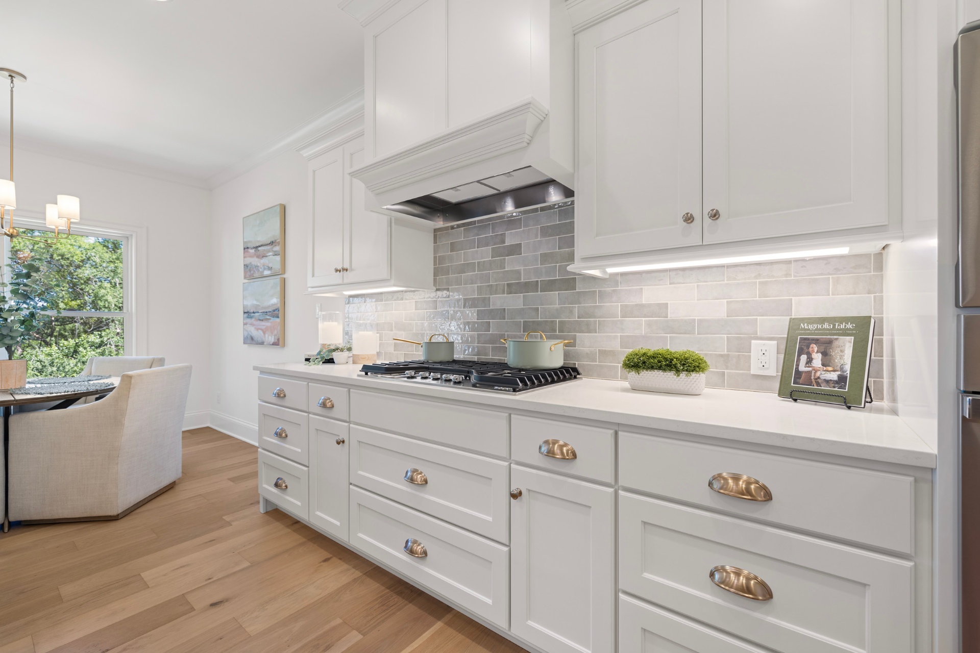 Galley kitchen with gas cooktop and custom hood