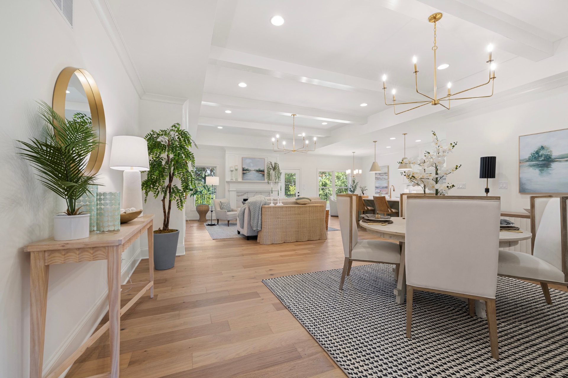 Great room with beamed ceiling and brass chandeliers