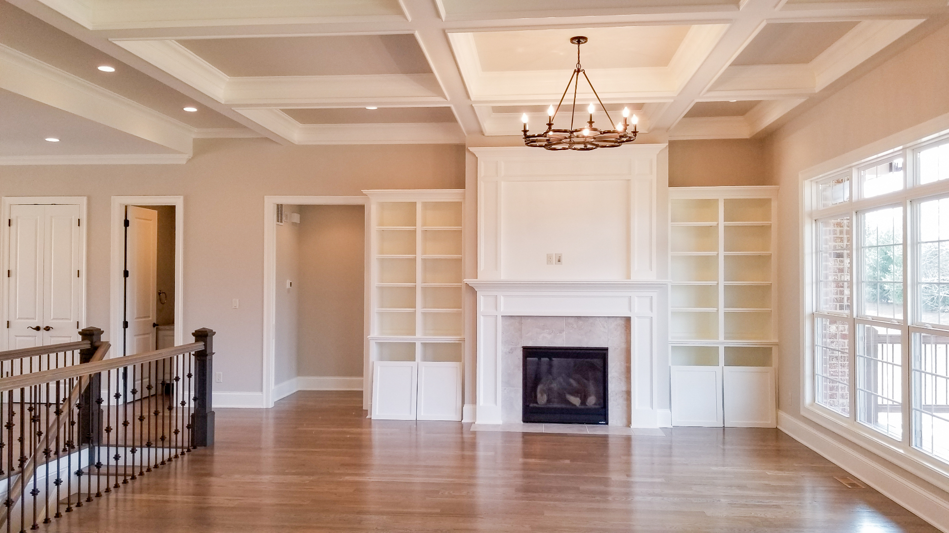 Family room with coffered ceiling and fireplace built-ins