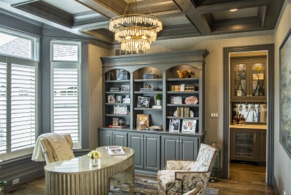 Home office with coffered ceiling and built-ins